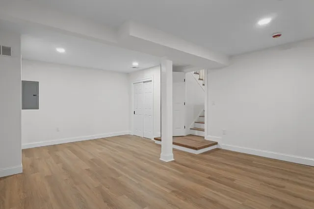 wooden floor in an empty room with a window