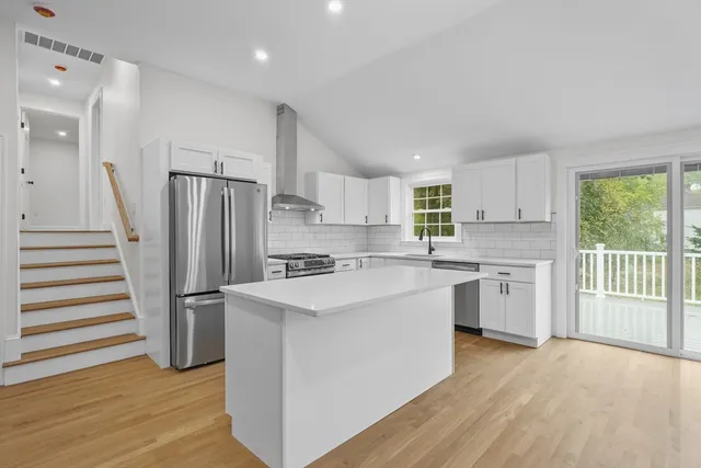 a kitchen with white cabinets and white appliances