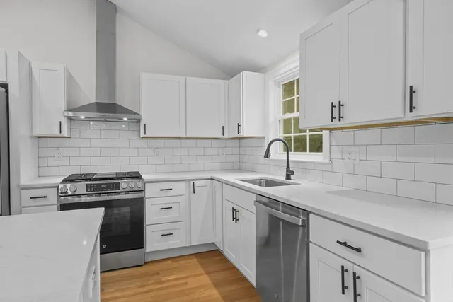 a kitchen with a sink stove and cabinets