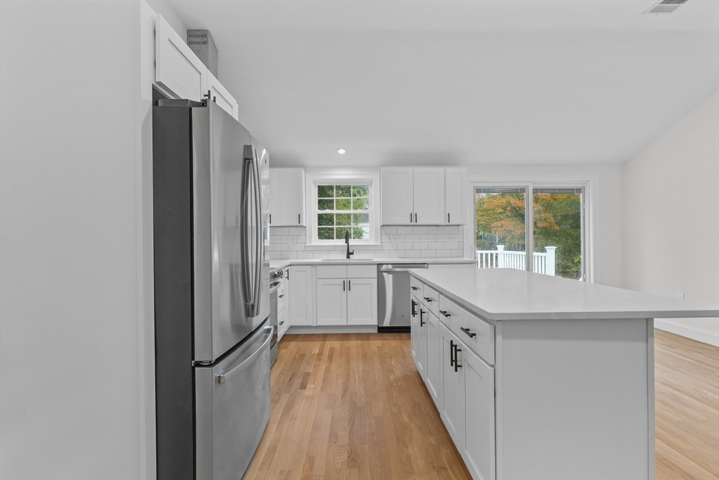 217 Central Street Framingham, MA 01701 - Photo 10 of 42 a kitchen with white cabinets appliances and a window