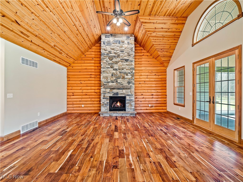 12740 Root Road Columbia Station, OH 44028 - Photo 8 of 47 Unfurnished living room with visible vents, high vaulted ceiling, a ceiling fan, and hardwood / wood-style floors