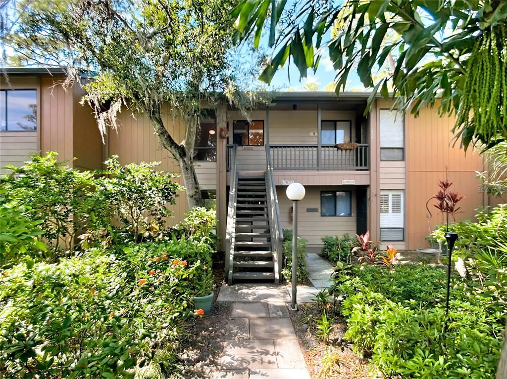 1703 Pelican Cove Road, Unit 455 Sarasota, FL 34231 - Photo 1 of 1 a front view of a house with plants