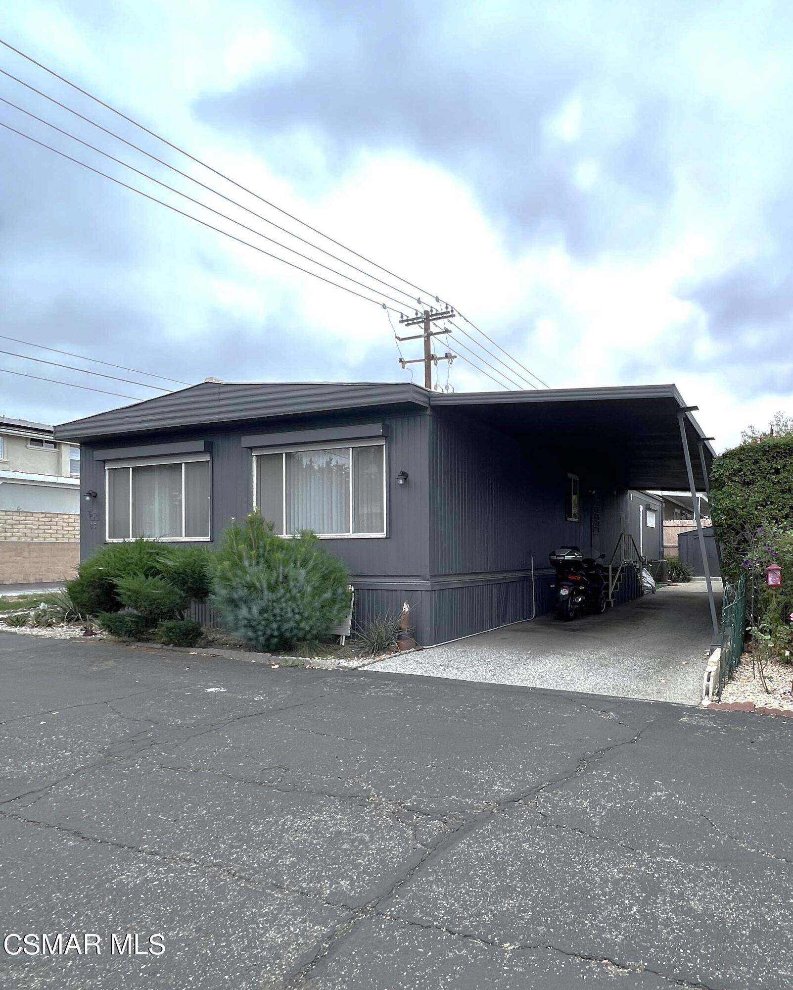 1550 Rory Lane, Unit 83 Simi Valley, CA 93063 - Photo 1 of 50 a front view of a house with a garden