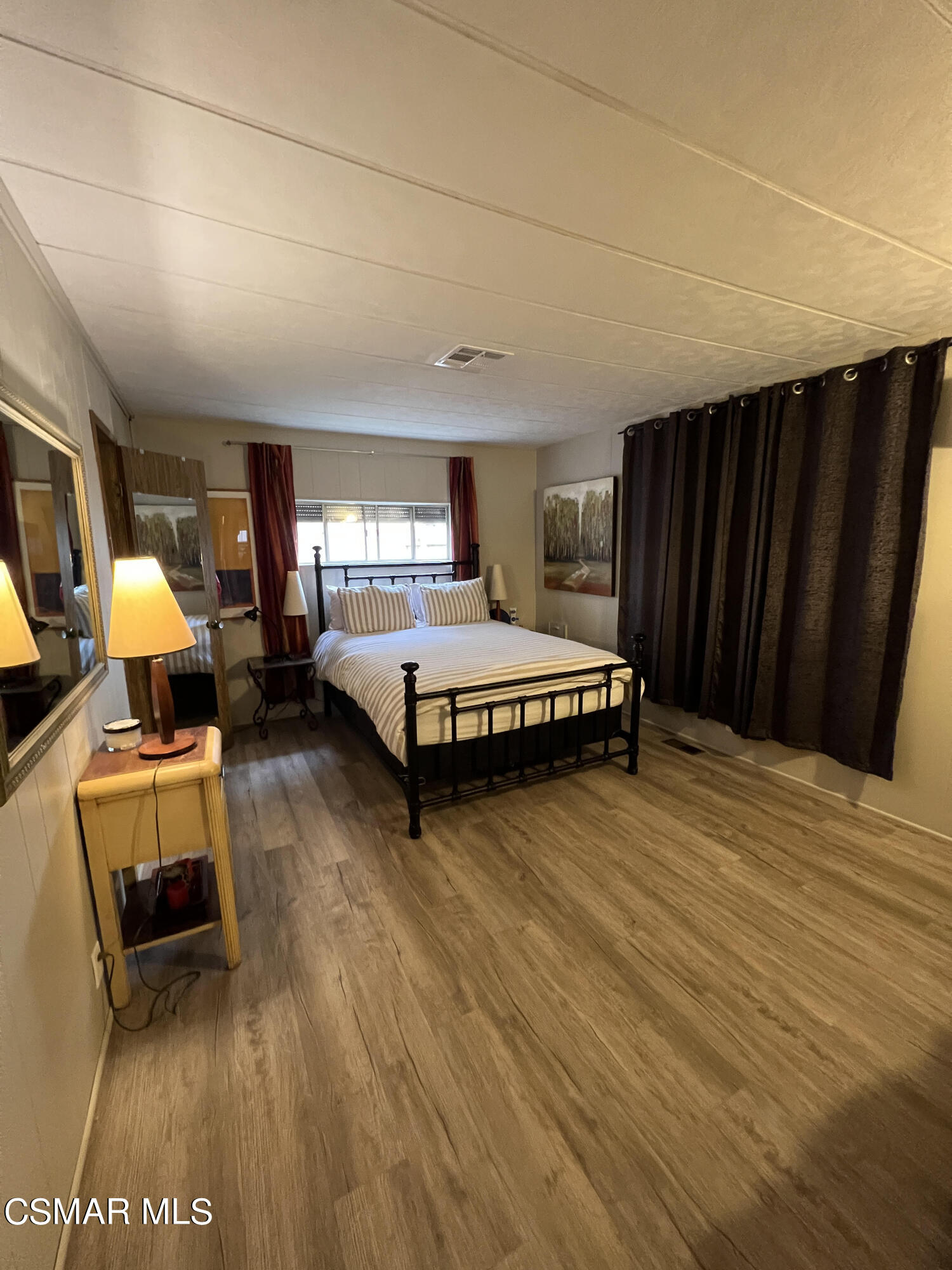1550 Rory Lane, Unit 83 Simi Valley, CA 93063 - Photo 21 of 50 a spacious bedroom with a bed and wooden floor