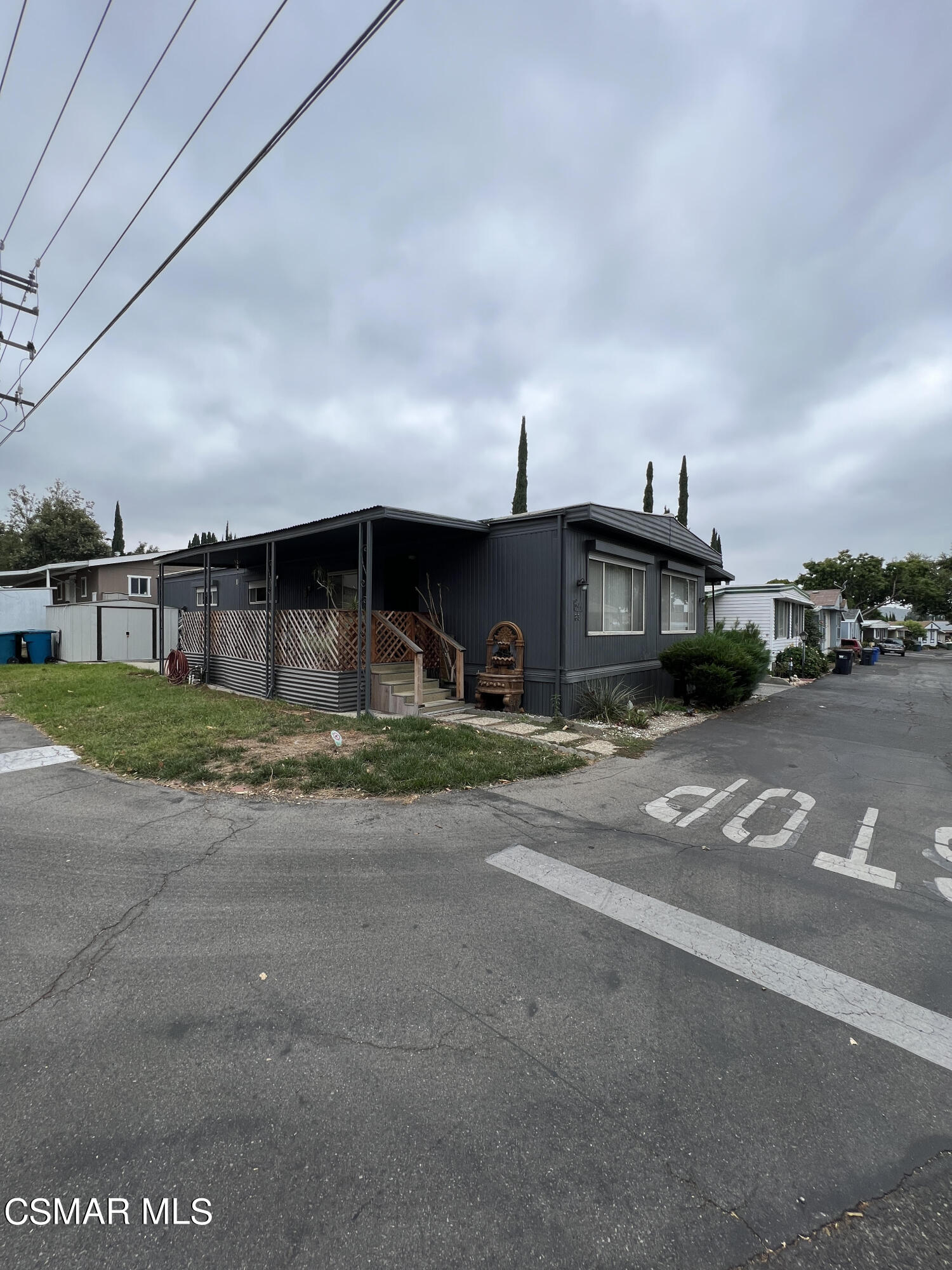1550 Rory Lane, Unit 83 Simi Valley, CA 93063 - Photo 4 of 50 a front view of a house with a yard and parking