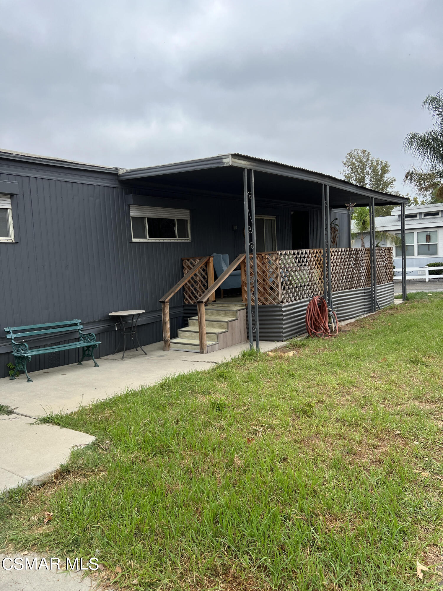 1550 Rory Lane, Unit 83 Simi Valley, CA 93063 - Photo 49 of 50 a view of a house with a yard and sitting area
