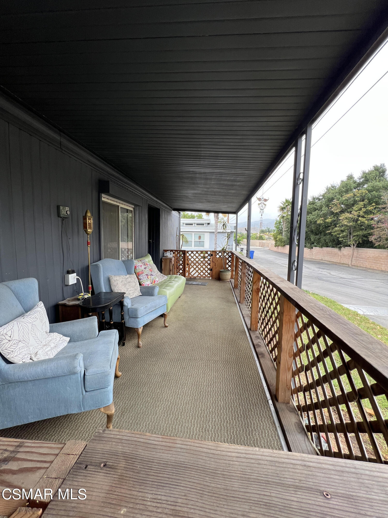 1550 Rory Lane, Unit 83 Simi Valley, CA 93063 - Photo 9 of 50 a balcony with chairs and wooden floor