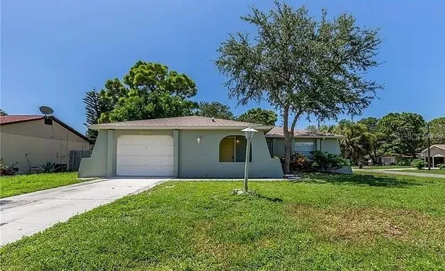 a front view of house with yard and trees