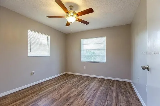 wooden floor in an empty room with a window