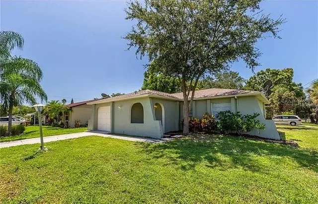 a front view of house with yard and green space