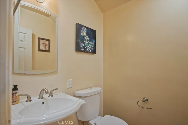 a bathroom with a sink mirror and toilet