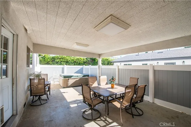 a view of a patio with a table and chairs