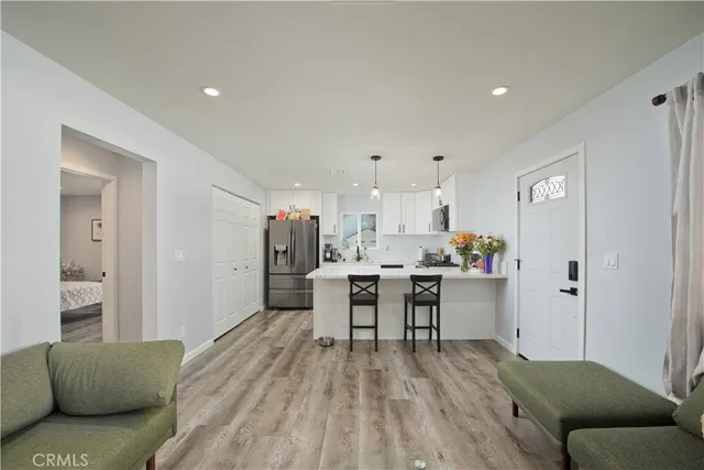 a living room with furniture and kitchen view