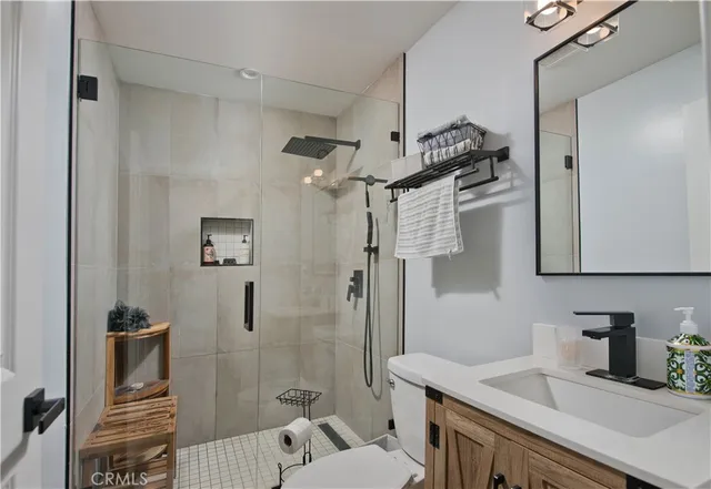 a bathroom with a sink toilet and shower