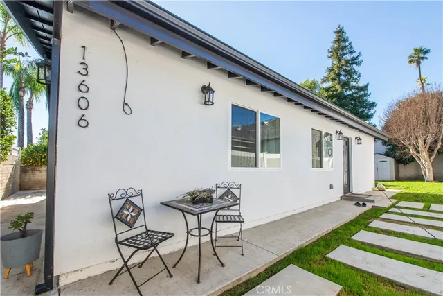 a backyard of a house with table and chairs