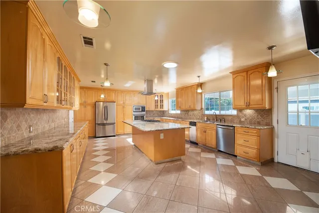 a large kitchen with lots of counter space and windows