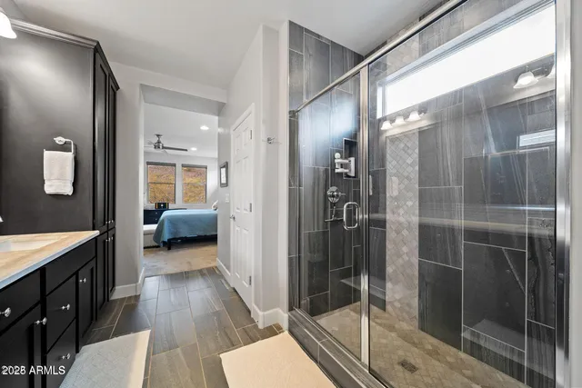 a en suite bathroom with a shower and a sink