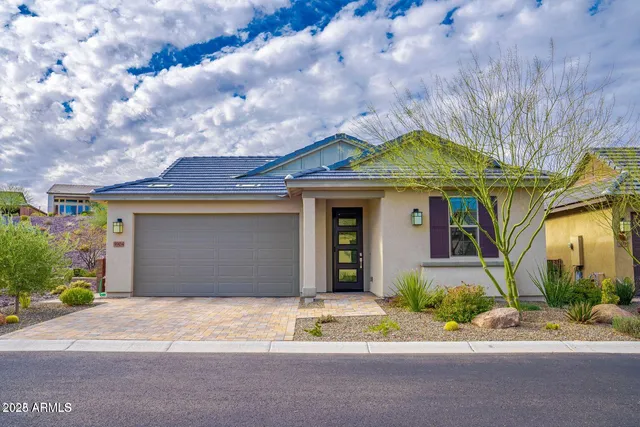 a front view of a house with a garden and pathway