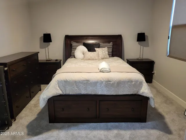 a bedroom with a bed and a night stand