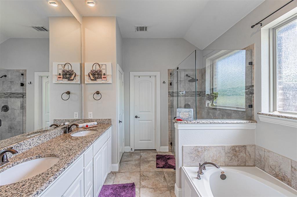 1805 Stetson Way Allen, TX 75002 - Photo 12 of 22 Bathroom featuring a dual vanity with granite countertops, undermount sinks, and bronze-finish fixtures