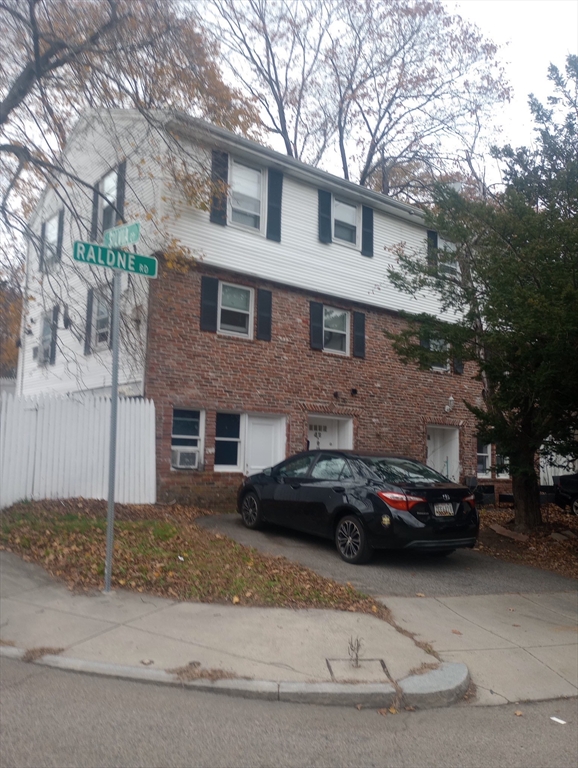 a couple of cars parked in front of a house