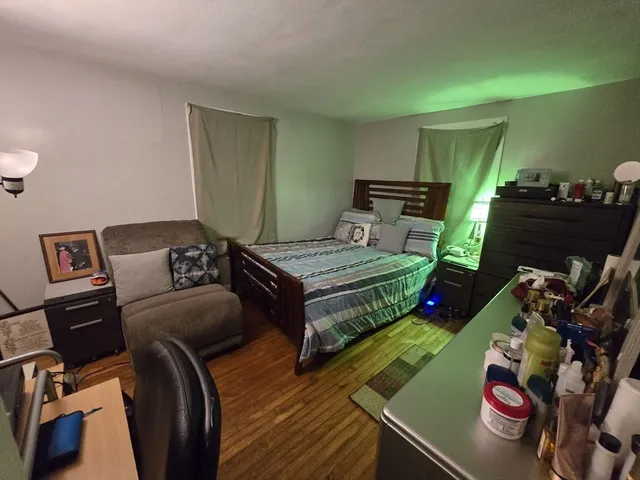 a bedroom with a bed and a tv