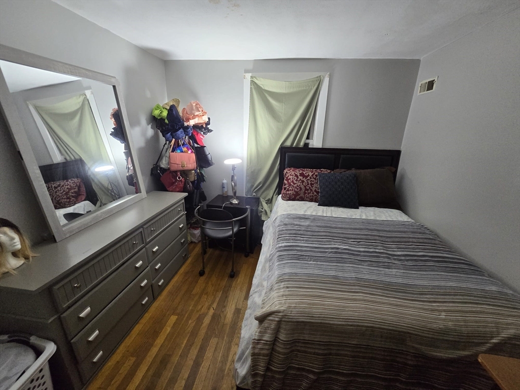 42 Raldne Road, Unit 1 Boston, MA 02136 - Photo 18 of 37 a bedroom with a bed and wooden floor