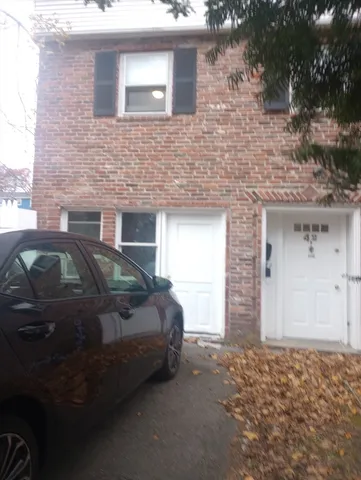 a front view of a house with parking space