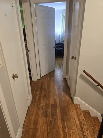 a view of a hallway and wooden floor