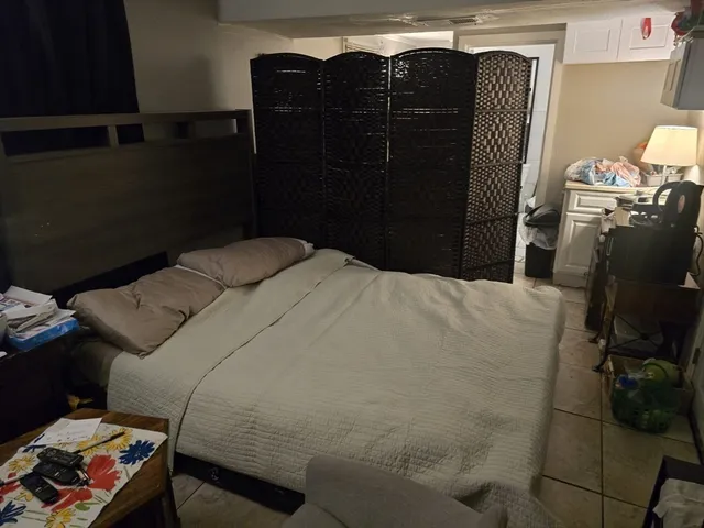 a bedroom with a bed and a mirror