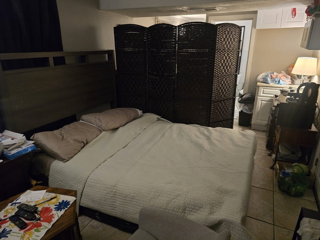 42 Raldne Road, Unit 1 Boston, MA 02136 - Photo 29 of 37 a bedroom with a bed and a mirror