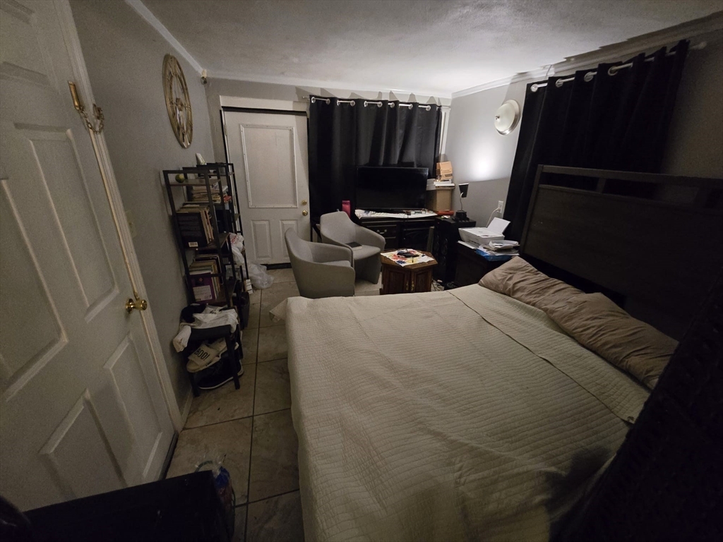 42 Raldne Road, Unit 1 Boston, MA 02136 - Photo 30 of 37 a bedroom with a bed and a television