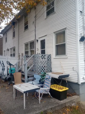 a view of a patio with a table and chairs and a fire pit