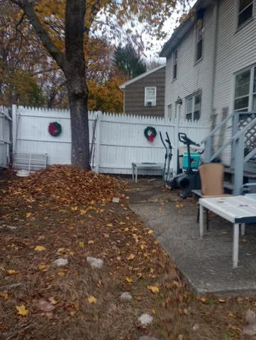 a backyard of a house with garage and parked