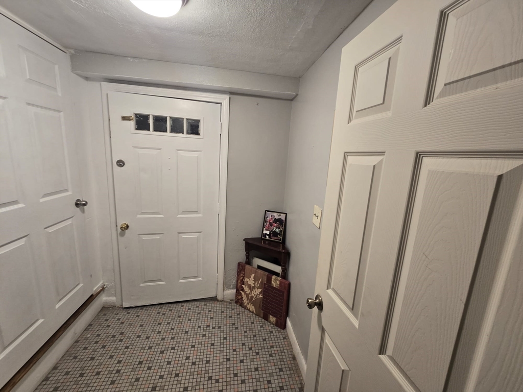 42 Raldne Road, Unit 1 Boston, MA 02136 - Photo 5 of 37 a view of a hallway with wooden floor and a cabinet