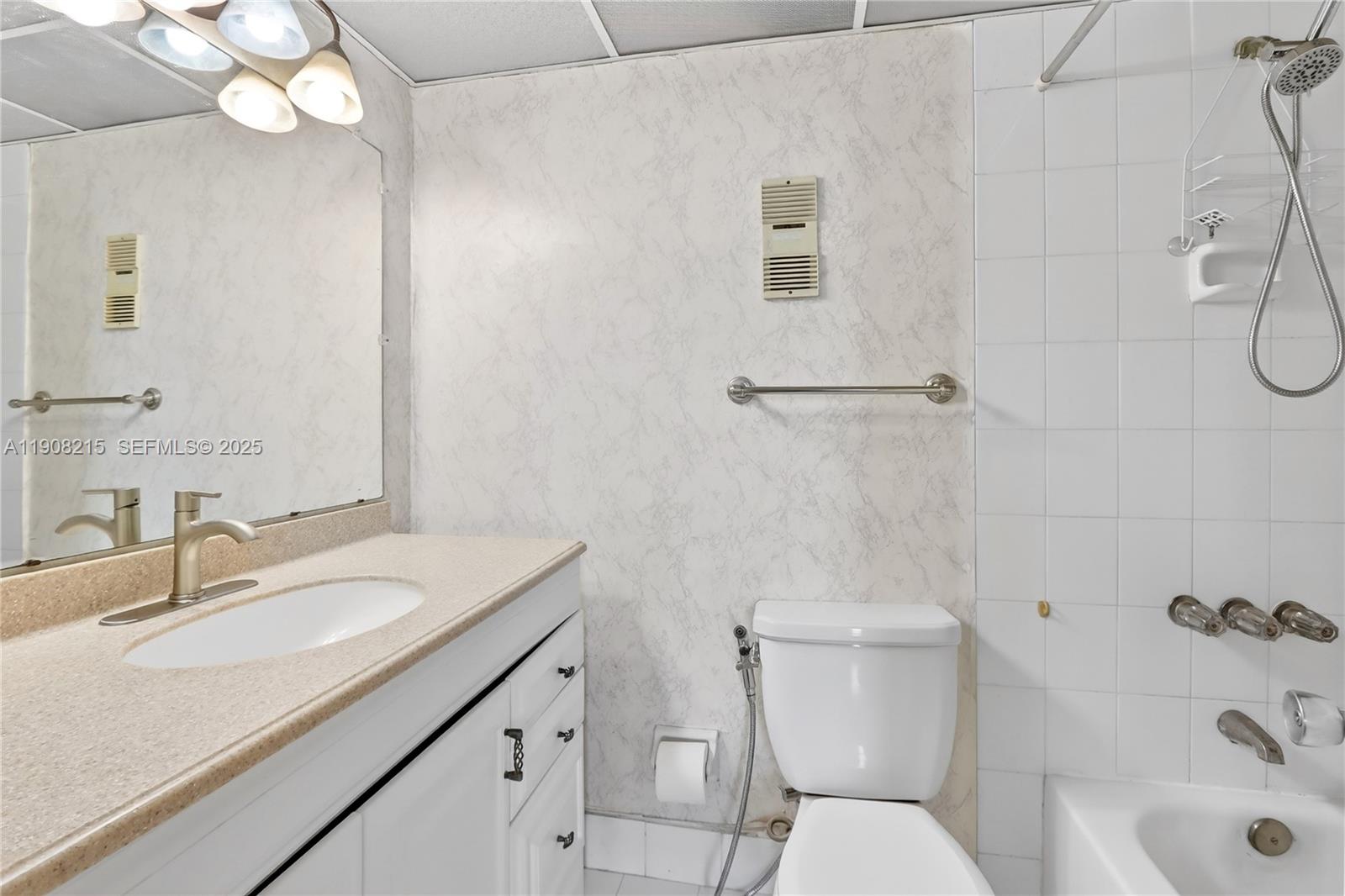 9401 Southwest 4th Street, Unit 3016 Miami, FL 33174 - Photo 14 of 17 a bathroom with a sink a toilet and shower