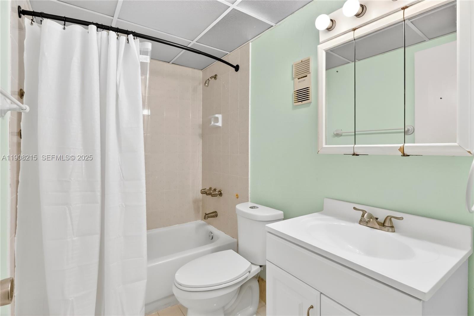 9401 Southwest 4th Street, Unit 3016 Miami, FL 33174 - Photo 15 of 17 a bathroom with a sink a toilet and shower