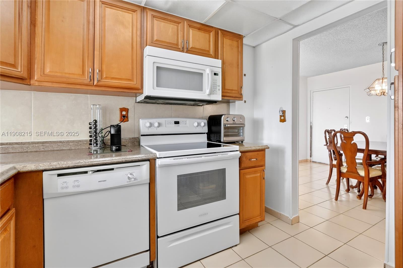 9401 Southwest 4th Street, Unit 3016 Miami, FL 33174 - Photo 7 of 17 a kitchen with stainless steel appliances granite countertop a stove a sink and a microwave