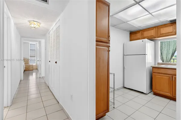 a view of a kitchen with a refrigerator