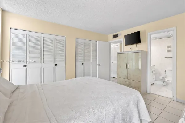 a spacious bedroom with a bed and a shower