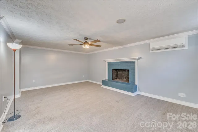 a view of a house with backyard fountain and sitting area