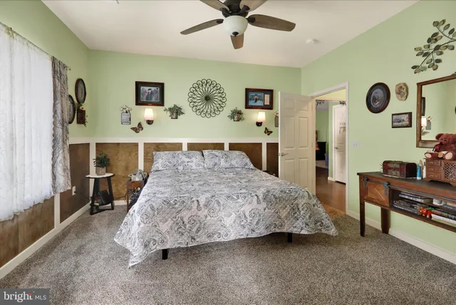 a spacious bedroom with a bed and a dresser