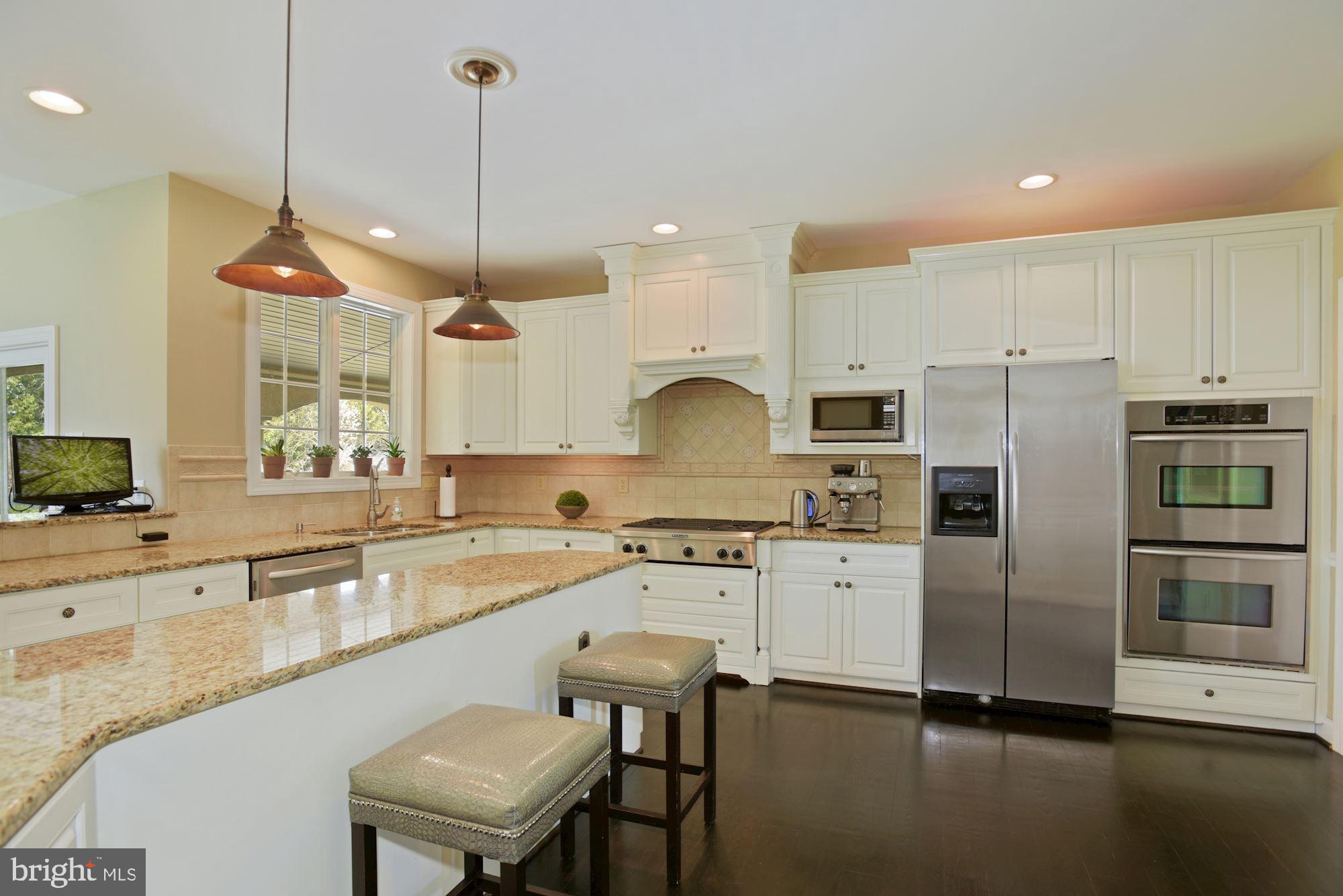 74 Balsam Road Lumberton, NJ 08048 - Photo 14 of 56 a kitchen with stainless steel appliances granite countertop a sink a stove a refrigerator cabinets and chairs