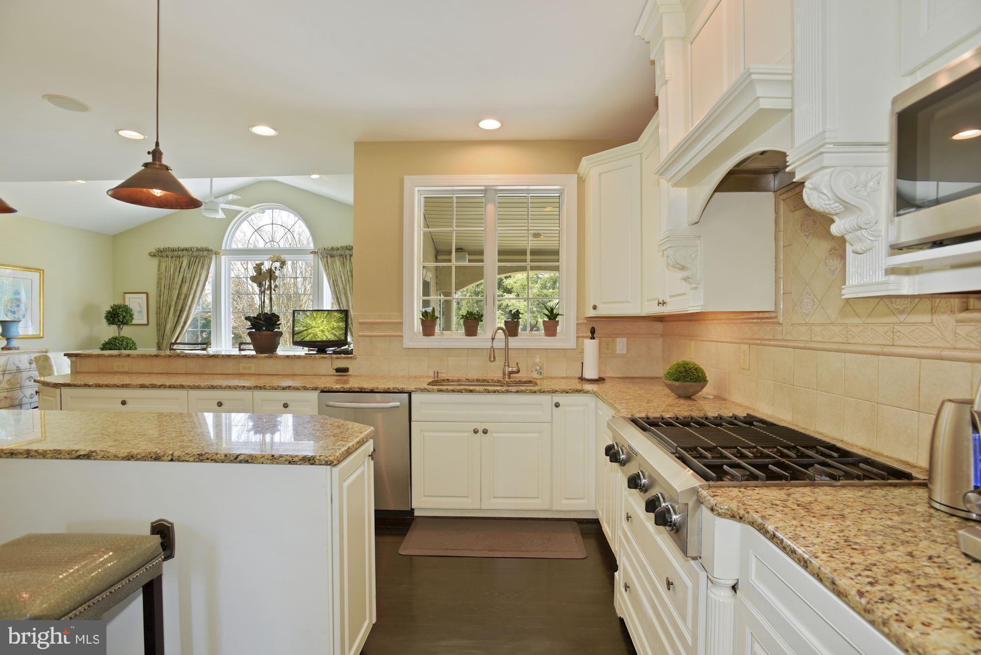 74 Balsam Road Lumberton, NJ 08048 - Photo 19 of 56 a kitchen with a stove a sink a kitchen island with wooden cabinets and floor