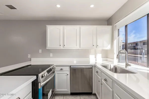 a kitchen with a sink stove and cabinets