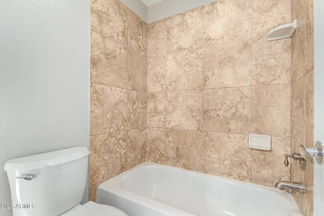 a bathroom with a bathtub and toilet