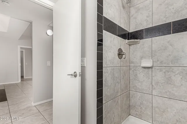 a bathroom with a shower and a glass door