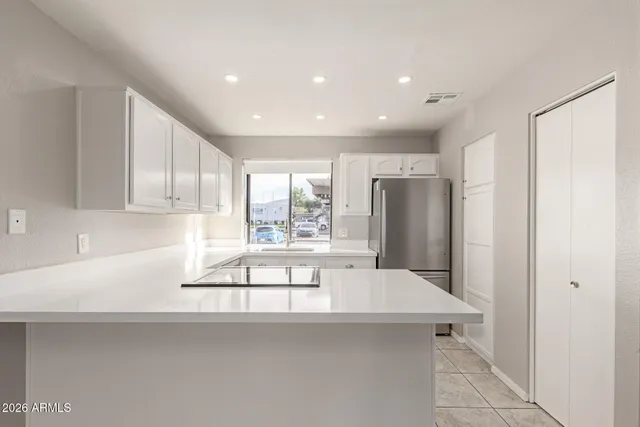 a kitchen with stainless steel appliances a sink and a refrigerator