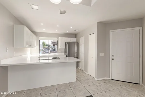 a kitchen with stainless steel appliances granite countertop a sink and a refrigerator