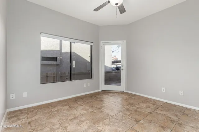 an empty room with mirror and windows